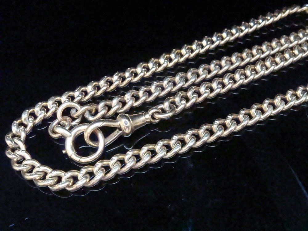An Edwardian 9ct yellow gold curb link chain featuring a swivel clip clasp and individual hallmark stamps on each link. View III