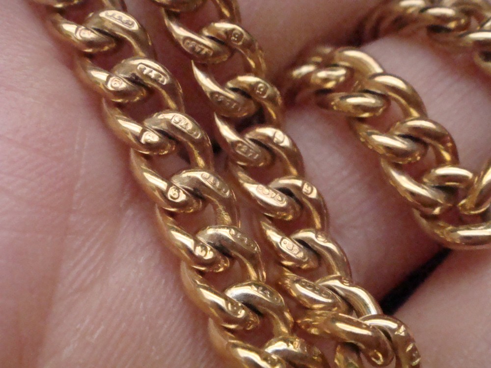 An Edwardian 9ct yellow gold curb link chain featuring a swivel clip clasp and individual hallmark stamps on each link. View VI
