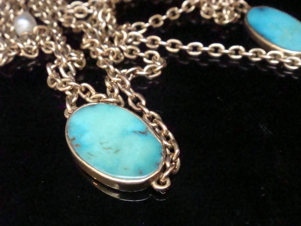 An Edwardian 15ct yellow gold longuard chain featuring oval turquoise cabochons set in collet mounts interspersed with natural pearls. View II