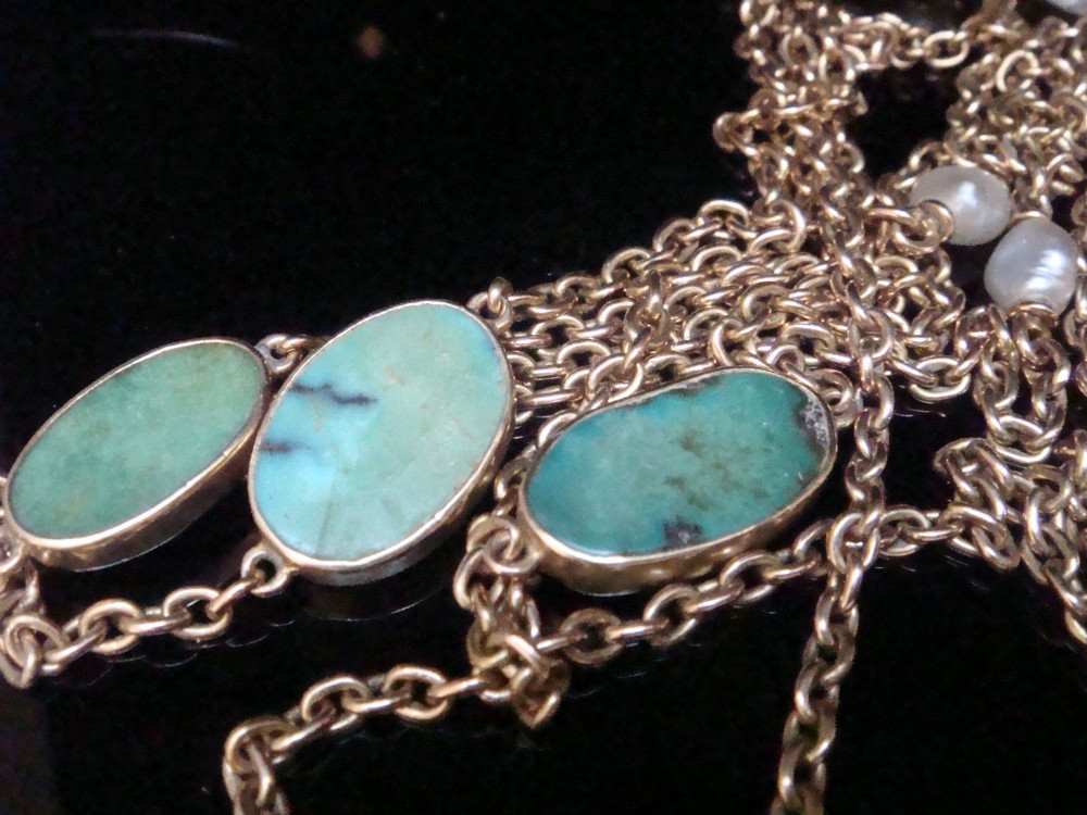 An Edwardian 15ct yellow gold longuard chain featuring oval turquoise cabochons set in collet mounts interspersed with natural pearls. View III