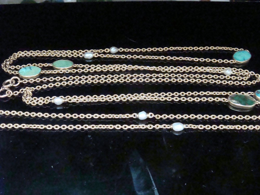 An Edwardian 15ct yellow gold longuard chain featuring oval turquoise cabochons set in collet mounts interspersed with natural pearls. View VI