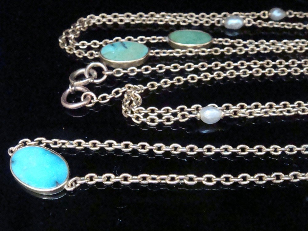 An Edwardian 15ct yellow gold longuard chain featuring oval turquoise cabochons set in collet mounts interspersed with natural pearls. View VII