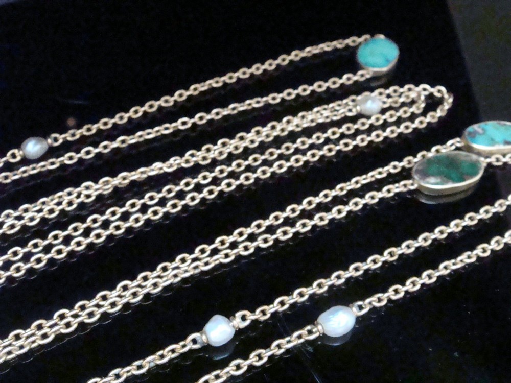 An Edwardian 15ct yellow gold longuard chain featuring oval turquoise cabochons set in collet mounts interspersed with natural pearls. View IX