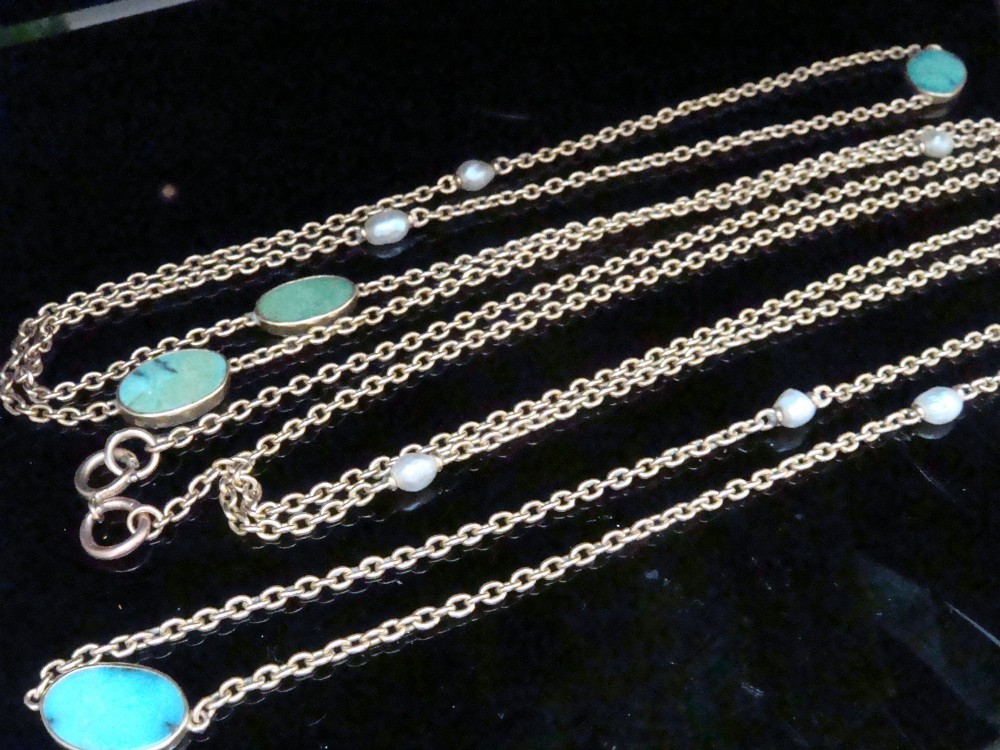 An Edwardian 15ct yellow gold longuard chain featuring oval turquoise cabochons set in collet mounts interspersed with natural pearls. View X