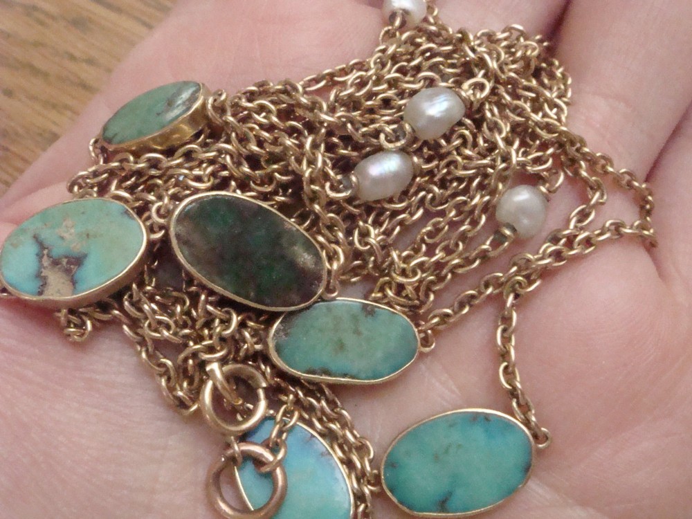 An Edwardian 15ct yellow gold longuard chain featuring oval turquoise cabochons set in collet mounts interspersed with natural pearls. View XI