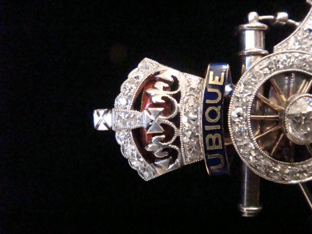 An Edwardian platinum and gold Royal Artillery badge brooch featuring blue guilloche enamel mottos and diamond settings. View III