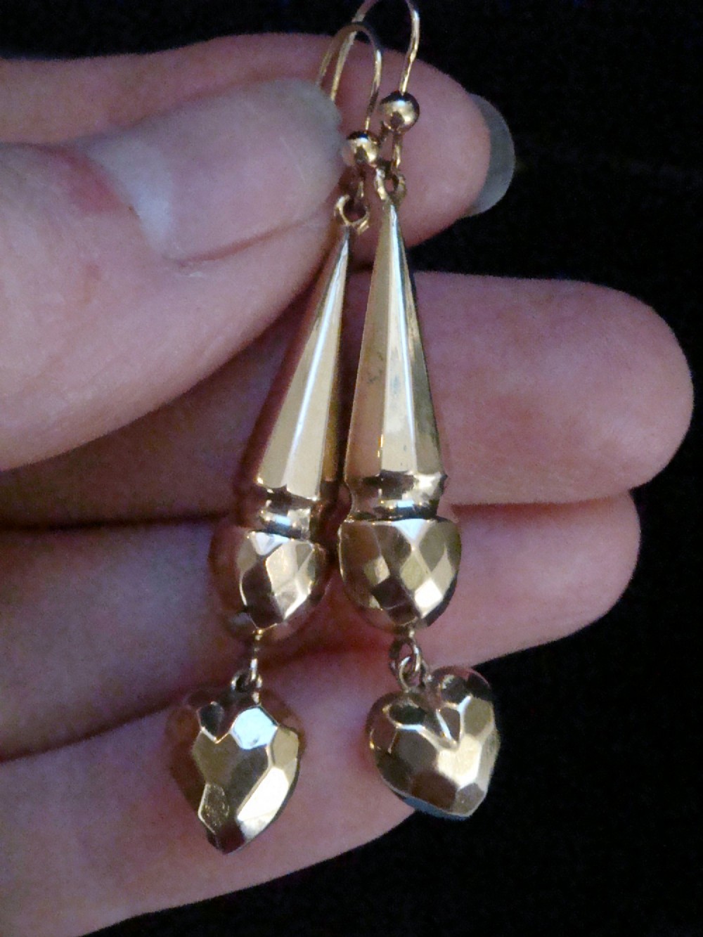 A pair of Edwardian 9ct yellow gold drop earrings featuring geometric faceted tapered bars and faceted heart pendants hanging from hook wires. View IV