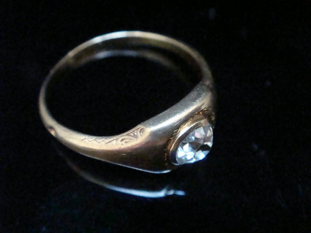 A Victorian 18ct yellow gold gypsy ring set with a single old cut diamond in a flush rubover bezel with hand engraving. View II