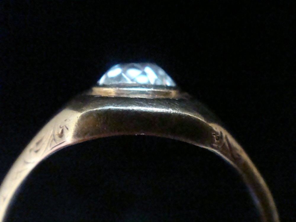 A Victorian 18ct yellow gold gypsy ring set with a single old cut diamond in a flush rubover bezel with hand engraving. View III
