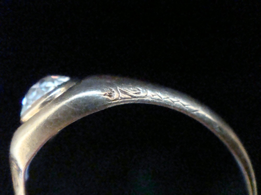 A Victorian 18ct yellow gold gypsy ring set with a single old cut diamond in a flush rubover bezel with hand engraving. View IV