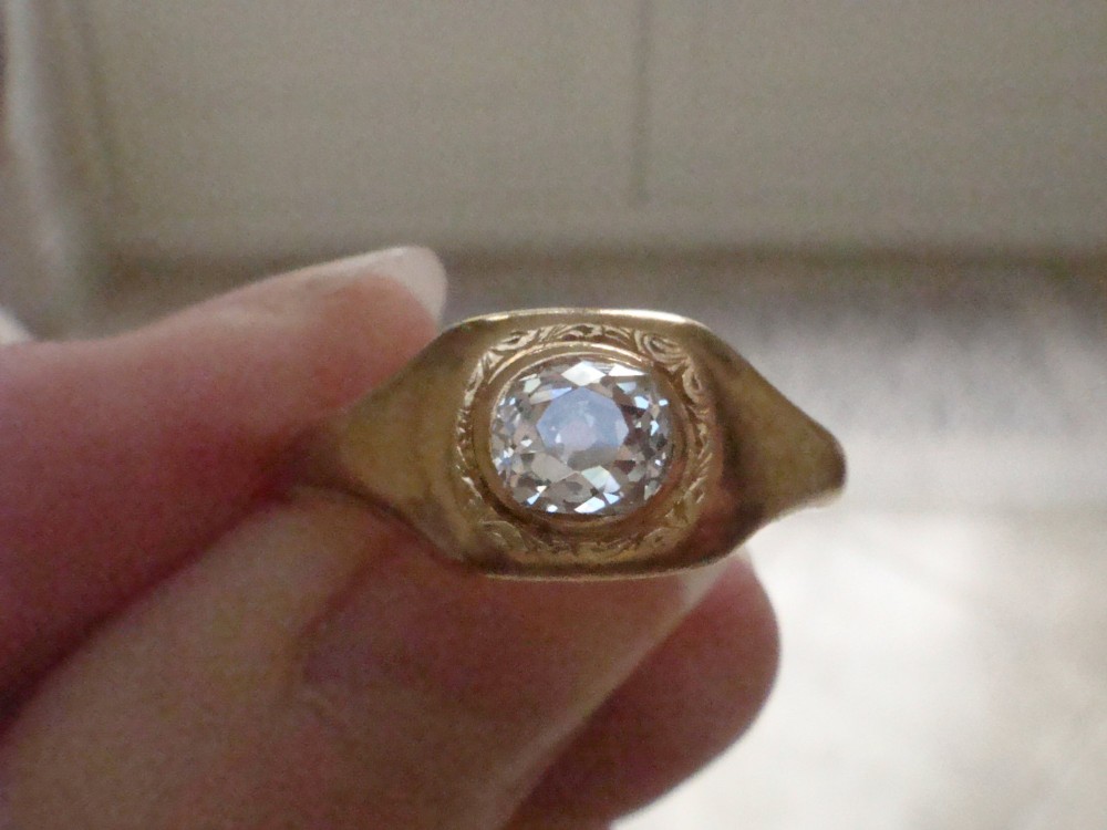 A Victorian 18ct yellow gold gypsy ring set with a single old cut diamond in a flush rubover bezel with hand engraving. View VIII