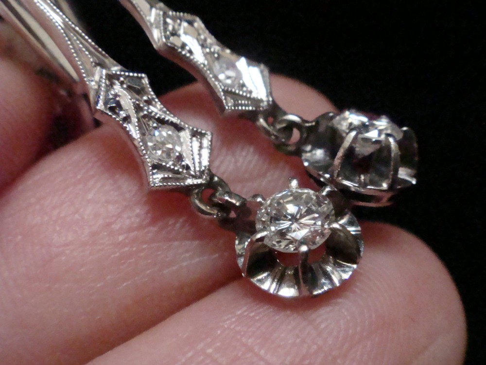 A pair of vintage 18ct white gold diamond drop earrings featuring geometric milgrained links and suspended round old-cut diamonds. View IV
