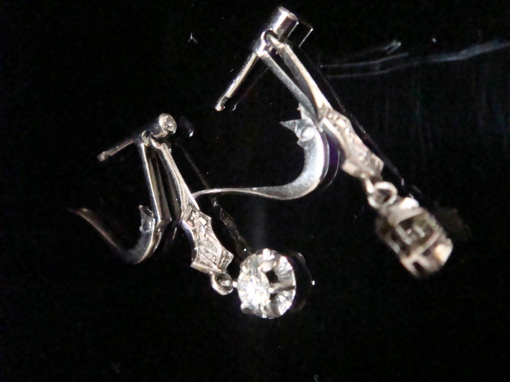 A pair of vintage 18ct white gold diamond drop earrings featuring geometric milgrained links and suspended round old-cut diamonds. View V