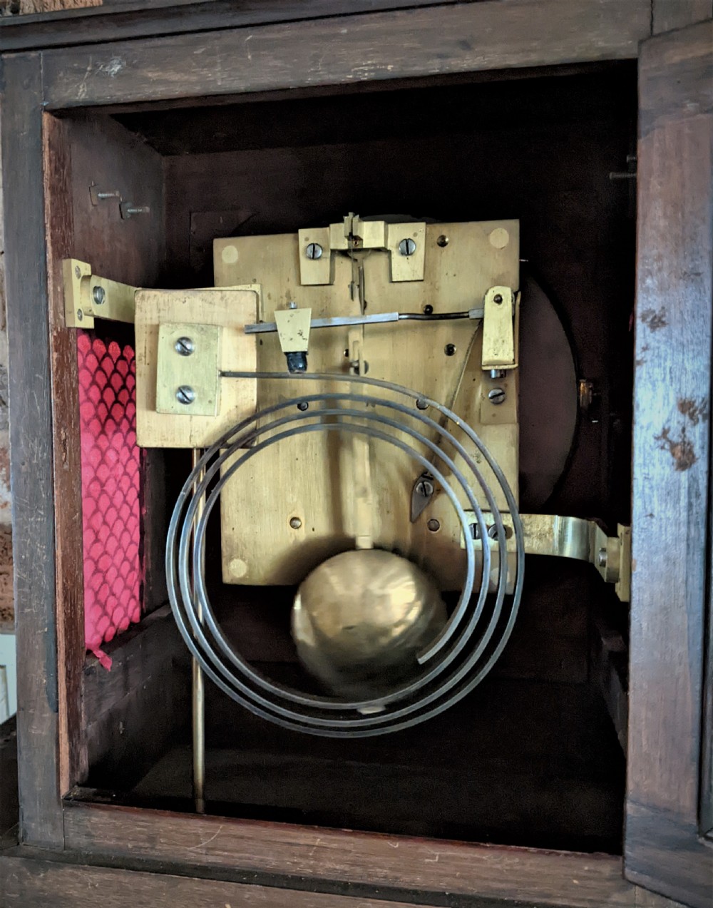 A 19th-century mahogany fusee bracket clock with a brass finial, brass ball feet, fluted wood trim, and a white dial displaying Roman numerals. View VII