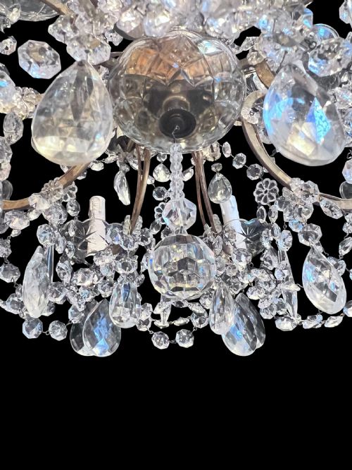 fig 1. A twelve-light antique Italian chandelier featuring two tiers of candle-style bulb holders, cut crystal drops, scalloped bobeches, and glass bead garlands.