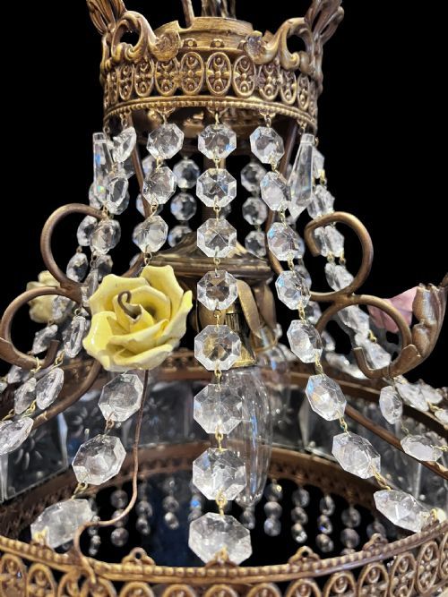 fig 1. An antique Italian brass three-light chandelier decorated with square cut glass panels, hanging crystal bead strands, and yellow porcelain flowers.