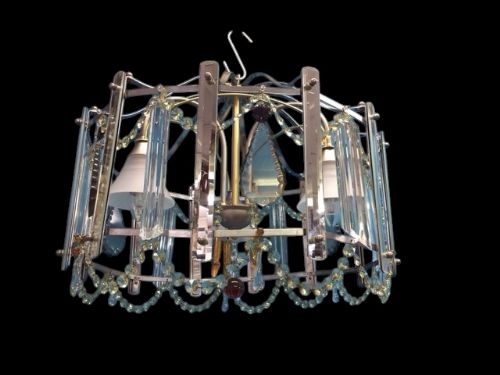 fig 1. An Art Deco pendant light featuring a chrome framework adorned with crystal garlands, glass prisms, and frosted inner light shades.