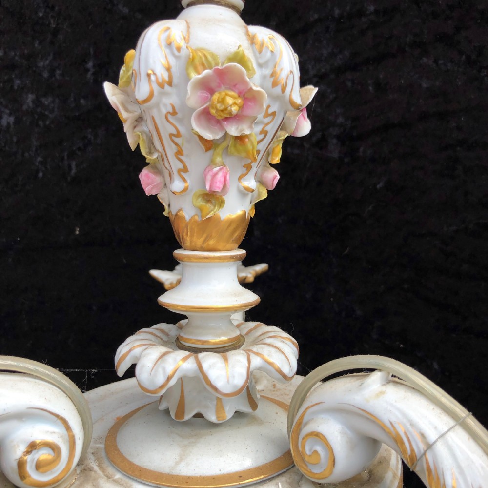 A three-arm Capodimonte porcelain chandelier with white glaze, gold scroll detailing, applied ceramic flowers, and candle-style bulb holders. View V