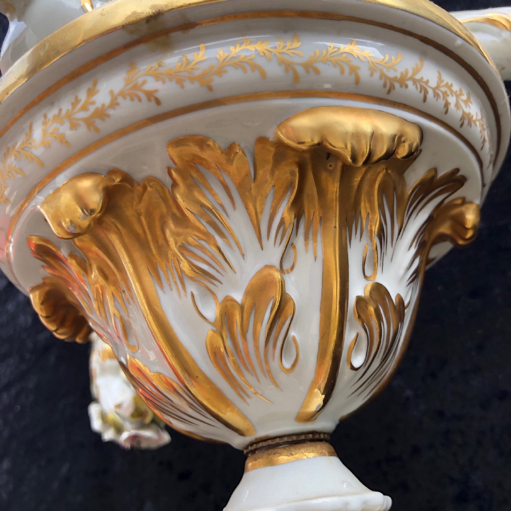 A three-arm Capodimonte porcelain chandelier with white glaze, gold scroll detailing, applied ceramic flowers, and candle-style bulb holders. View IX