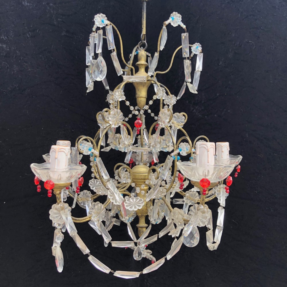 A five-light Florentine chandelier featuring a gilt metal frame adorned with clear crystal drops, floral glass rosettes, and coloured accent beads.