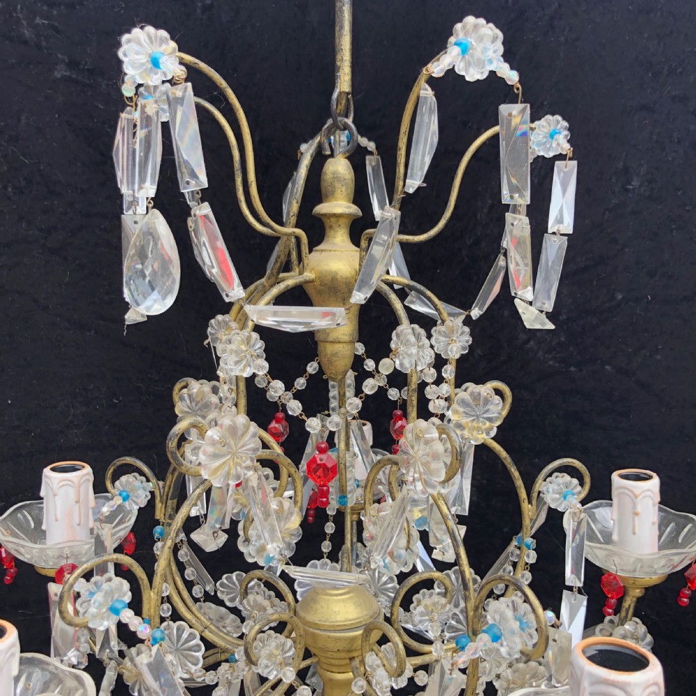 A five-light Florentine chandelier featuring a gilt metal frame adorned with clear crystal drops, floral glass rosettes, and coloured accent beads. View II