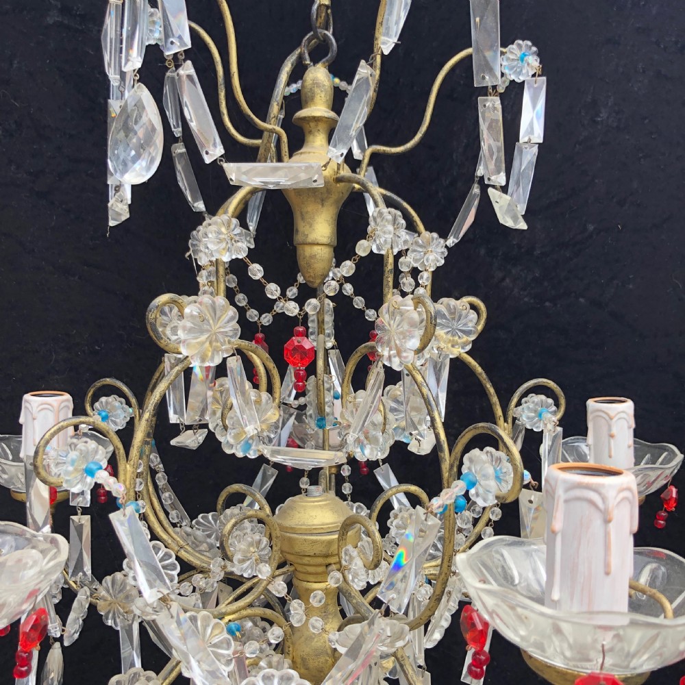 A five-light Florentine chandelier featuring a gilt metal frame adorned with clear crystal drops, floral glass rosettes, and coloured accent beads. View III