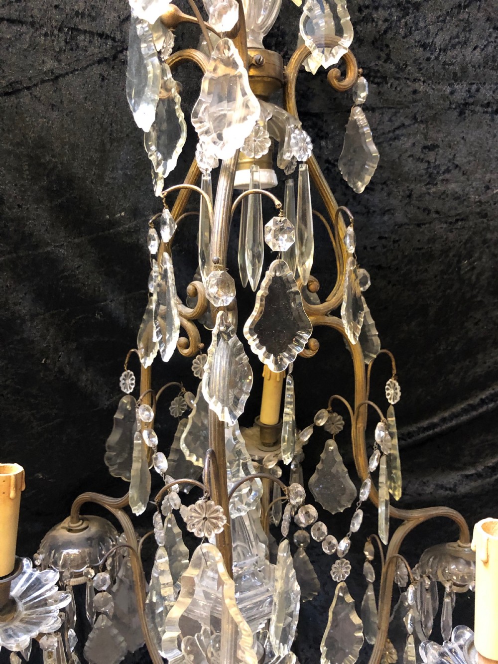 An antique French nine-light chandelier featuring a gilt metal frame dressed with clear faceted cut-glass crystals and pendeloque drops. View IV