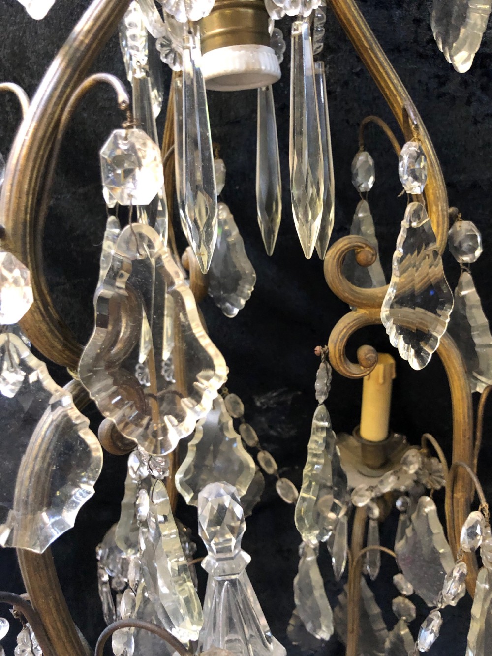 An antique French nine-light chandelier featuring a gilt metal frame dressed with clear faceted cut-glass crystals and pendeloque drops. View VI