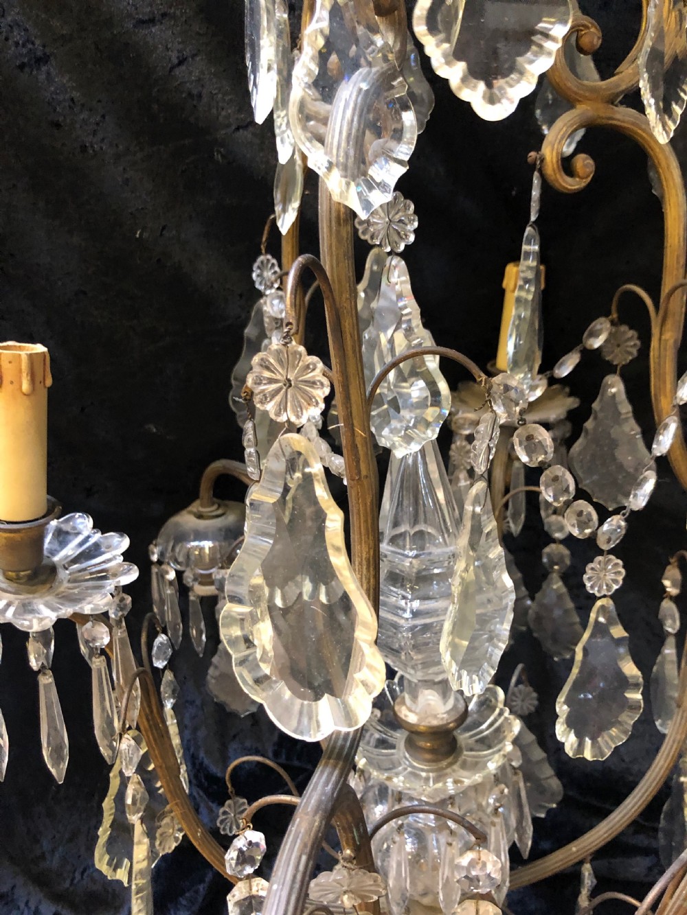 An antique French nine-light chandelier featuring a gilt metal frame dressed with clear faceted cut-glass crystals and pendeloque drops. View VIII