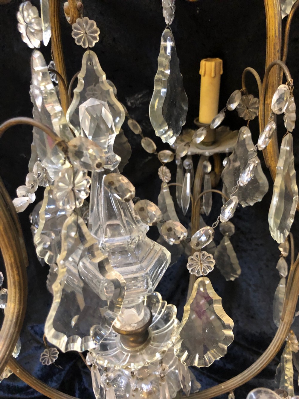 An antique French nine-light chandelier featuring a gilt metal frame dressed with clear faceted cut-glass crystals and pendeloque drops. View IX