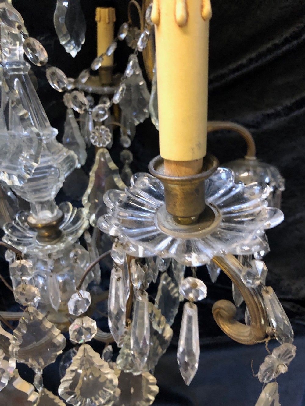 An antique French nine-light chandelier featuring a gilt metal frame dressed with clear faceted cut-glass crystals and pendeloque drops. View X