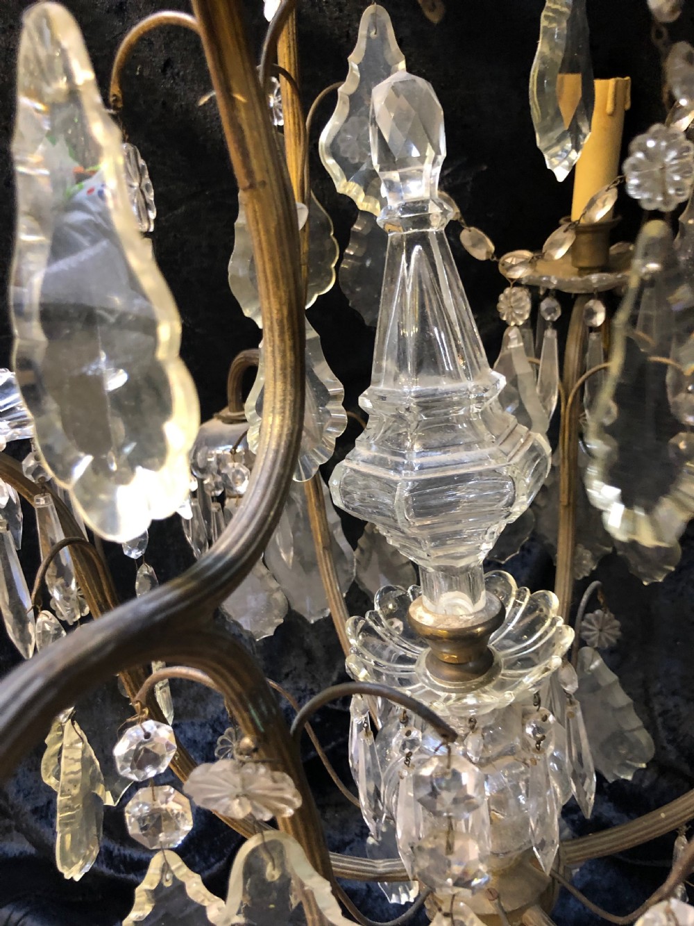 An antique French nine-light chandelier featuring a gilt metal frame dressed with clear faceted cut-glass crystals and pendeloque drops. View XI