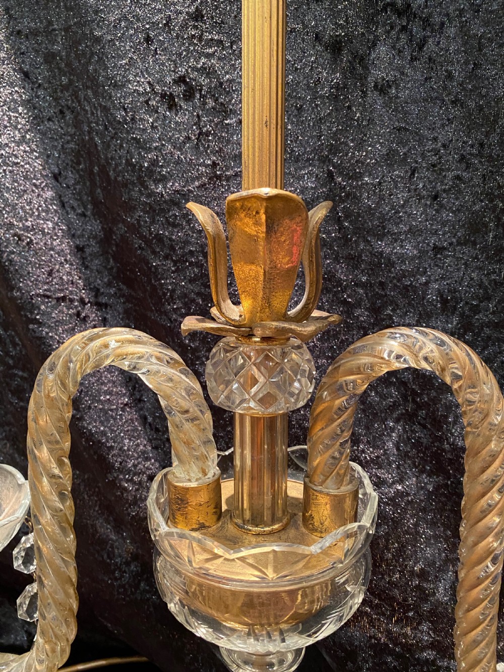 A pair of gilt brass and cut crystal two-arm candelabra table lamps featuring twisted glass arms, cascading crystal droplets, and stepped bases. View V