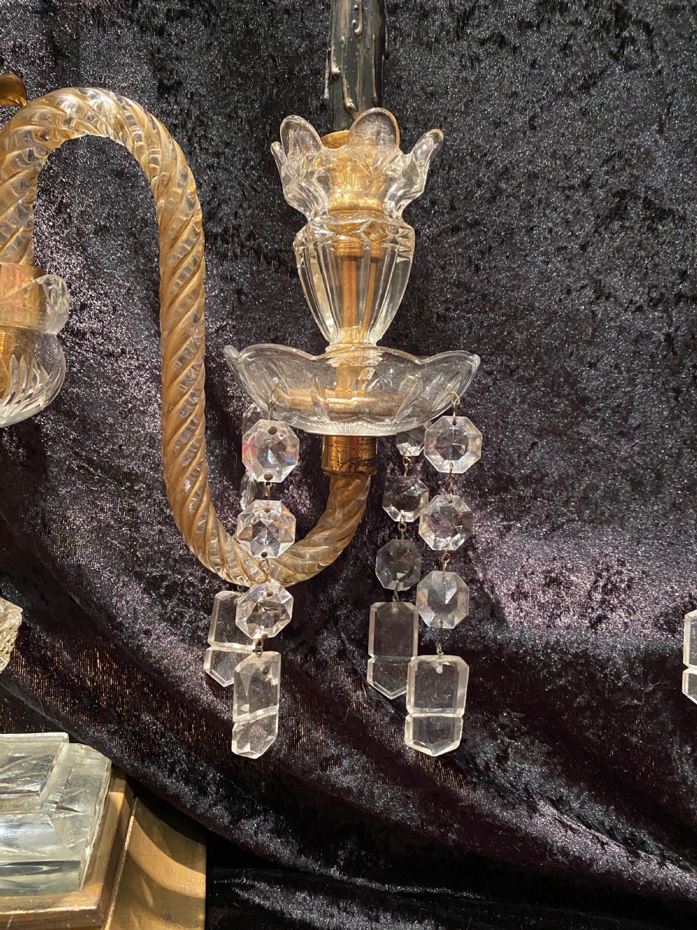 A pair of gilt brass and cut crystal two-arm candelabra table lamps featuring twisted glass arms, cascading crystal droplets, and stepped bases. View X
