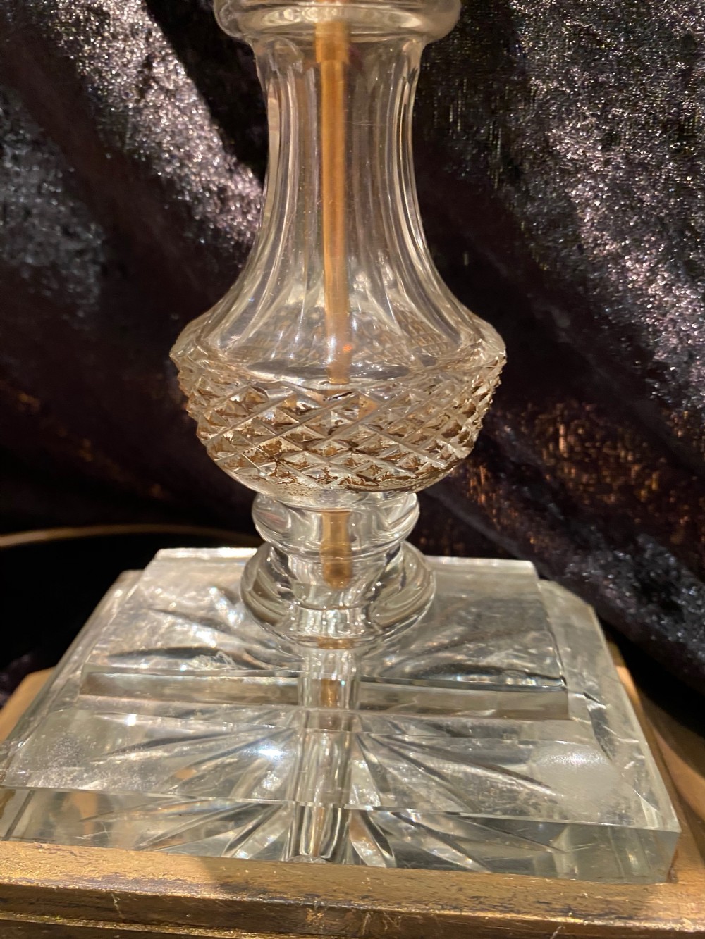 A pair of gilt brass and cut crystal two-arm candelabra table lamps featuring twisted glass arms, cascading crystal droplets, and stepped bases. View XII