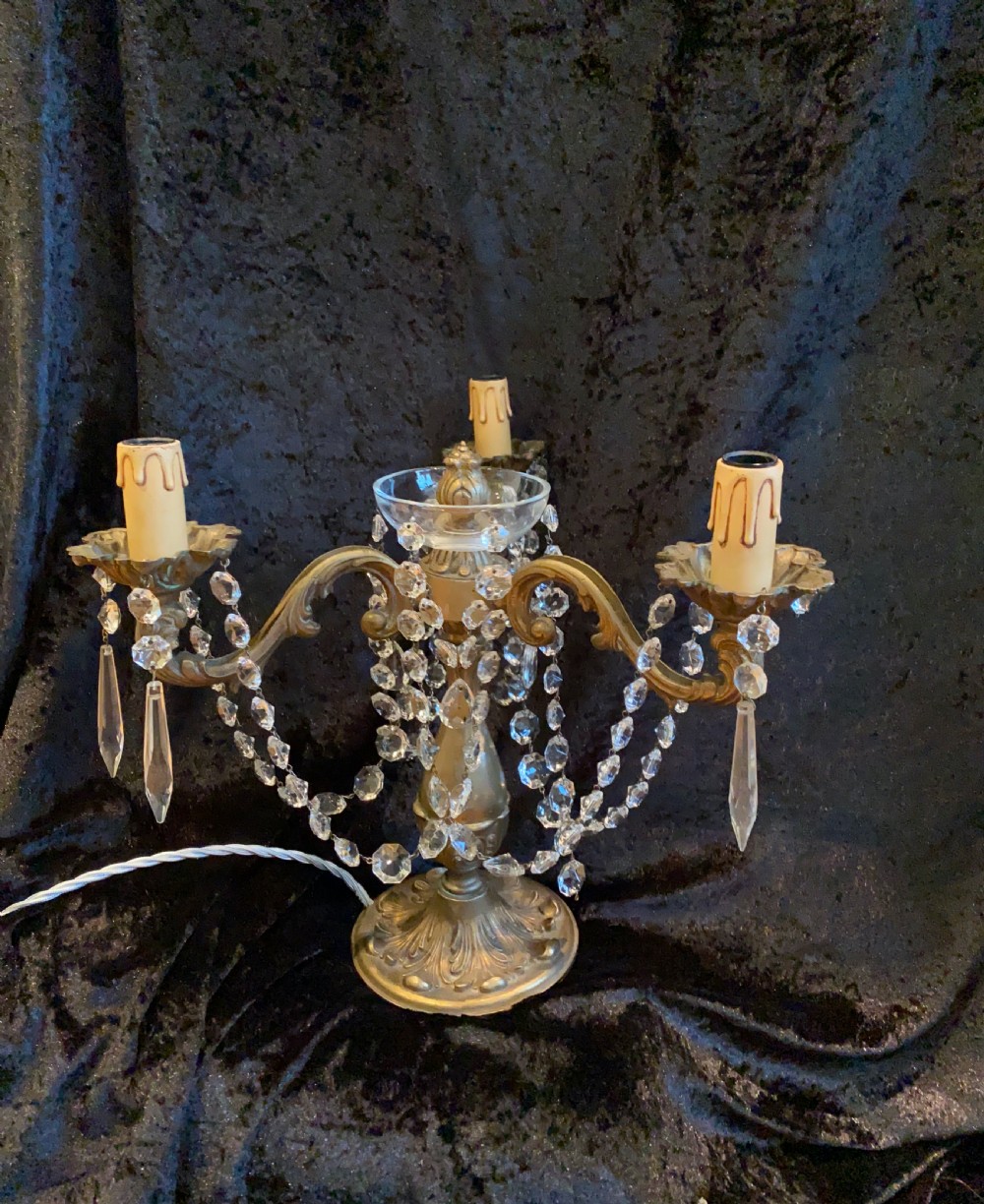 A pair of French gilt brass three-light candelabra table lamps adorned with hanging clear crystal prisms and beads. View II