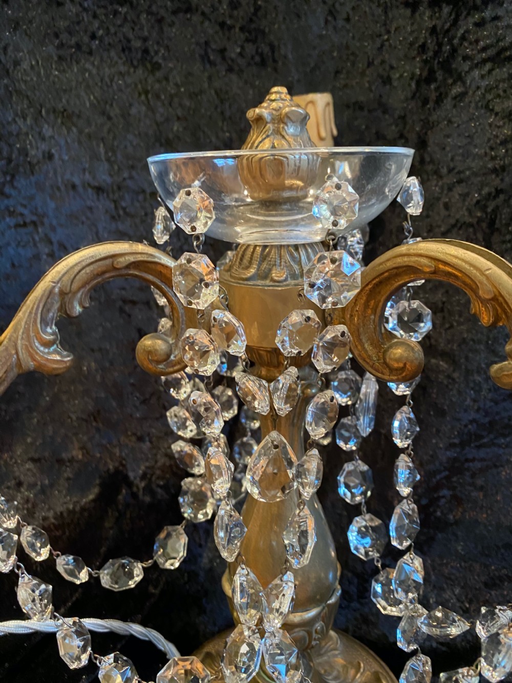 A pair of French gilt brass three-light candelabra table lamps adorned with hanging clear crystal prisms and beads. View V