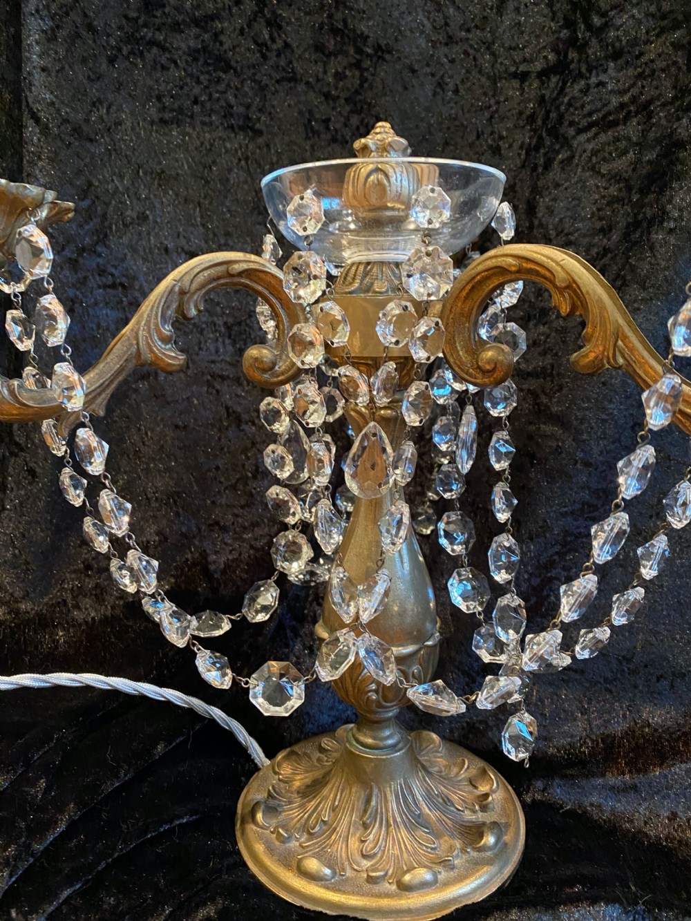 A pair of French gilt brass three-light candelabra table lamps adorned with hanging clear crystal prisms and beads. View VI