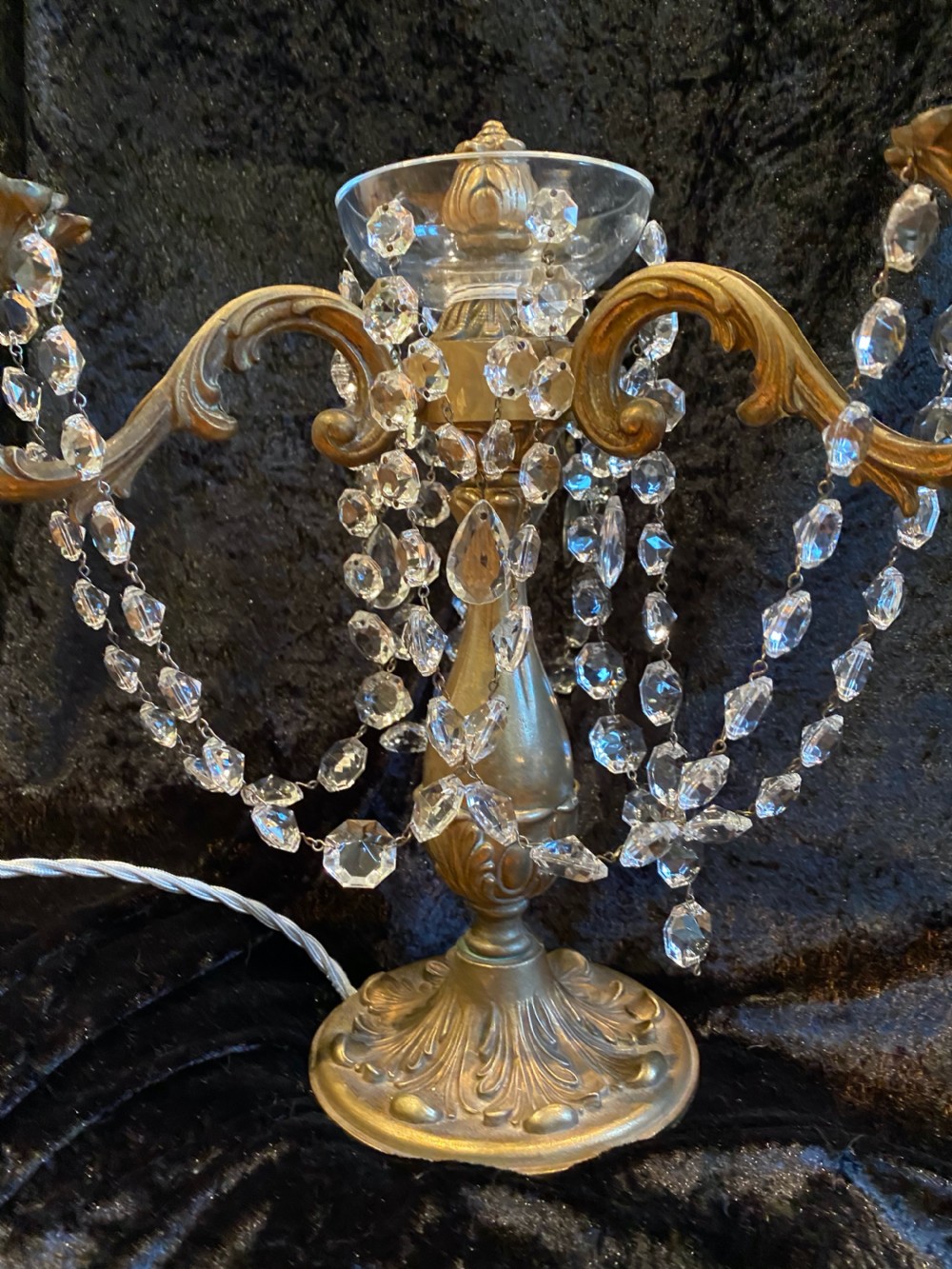 A pair of French gilt brass three-light candelabra table lamps adorned with hanging clear crystal prisms and beads. View VIII
