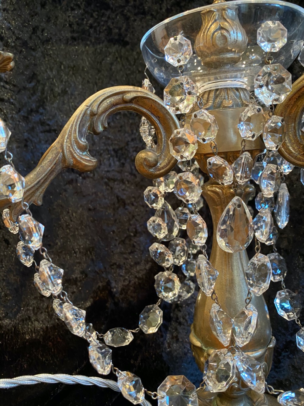 A pair of French gilt brass three-light candelabra table lamps adorned with hanging clear crystal prisms and beads. View IX