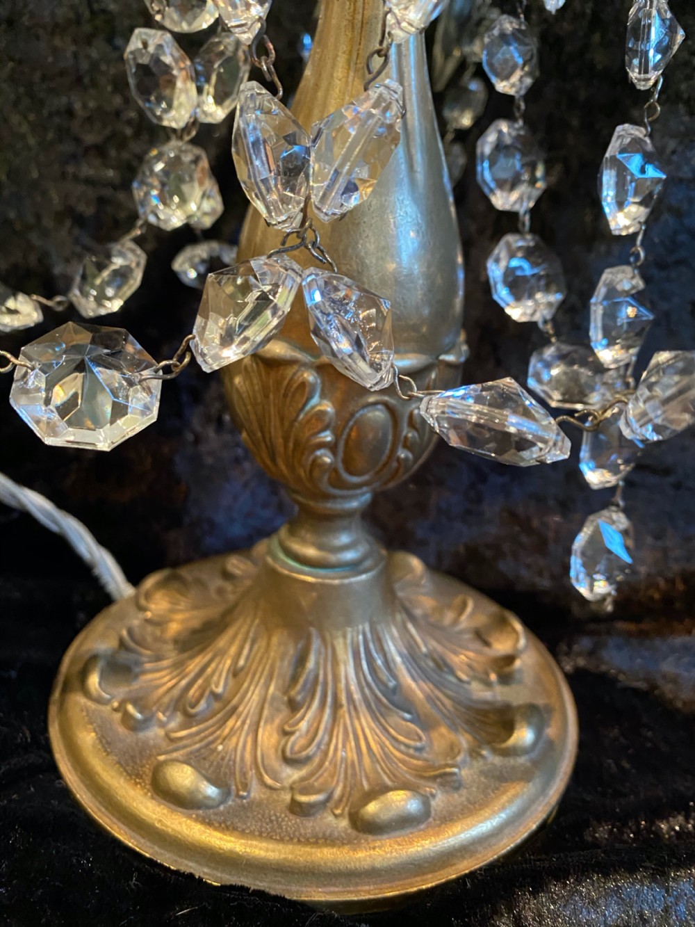 A pair of French gilt brass three-light candelabra table lamps adorned with hanging clear crystal prisms and beads. View X