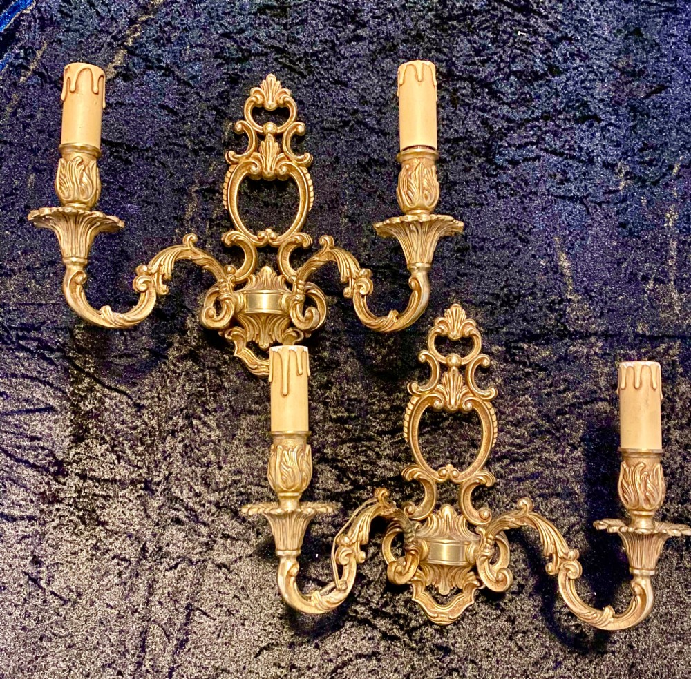 A PAIR OF TWO ARM FRENCH BRASS WALL-LIGHTS WITH OPEN FRAME