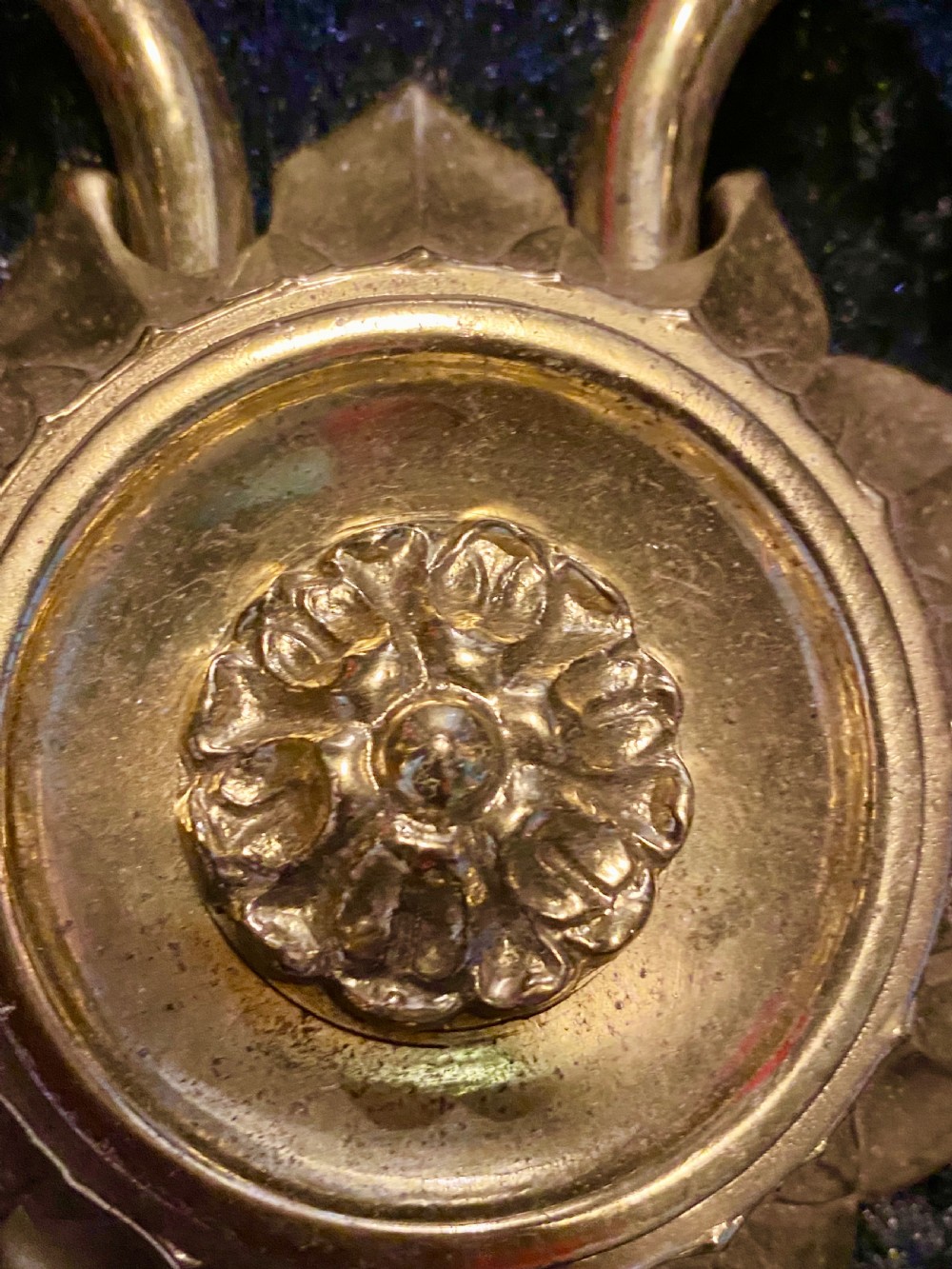 A pair of cast brass two-light wall sconces featuring sunburst backplates and curved acanthus leaf arms. View IV