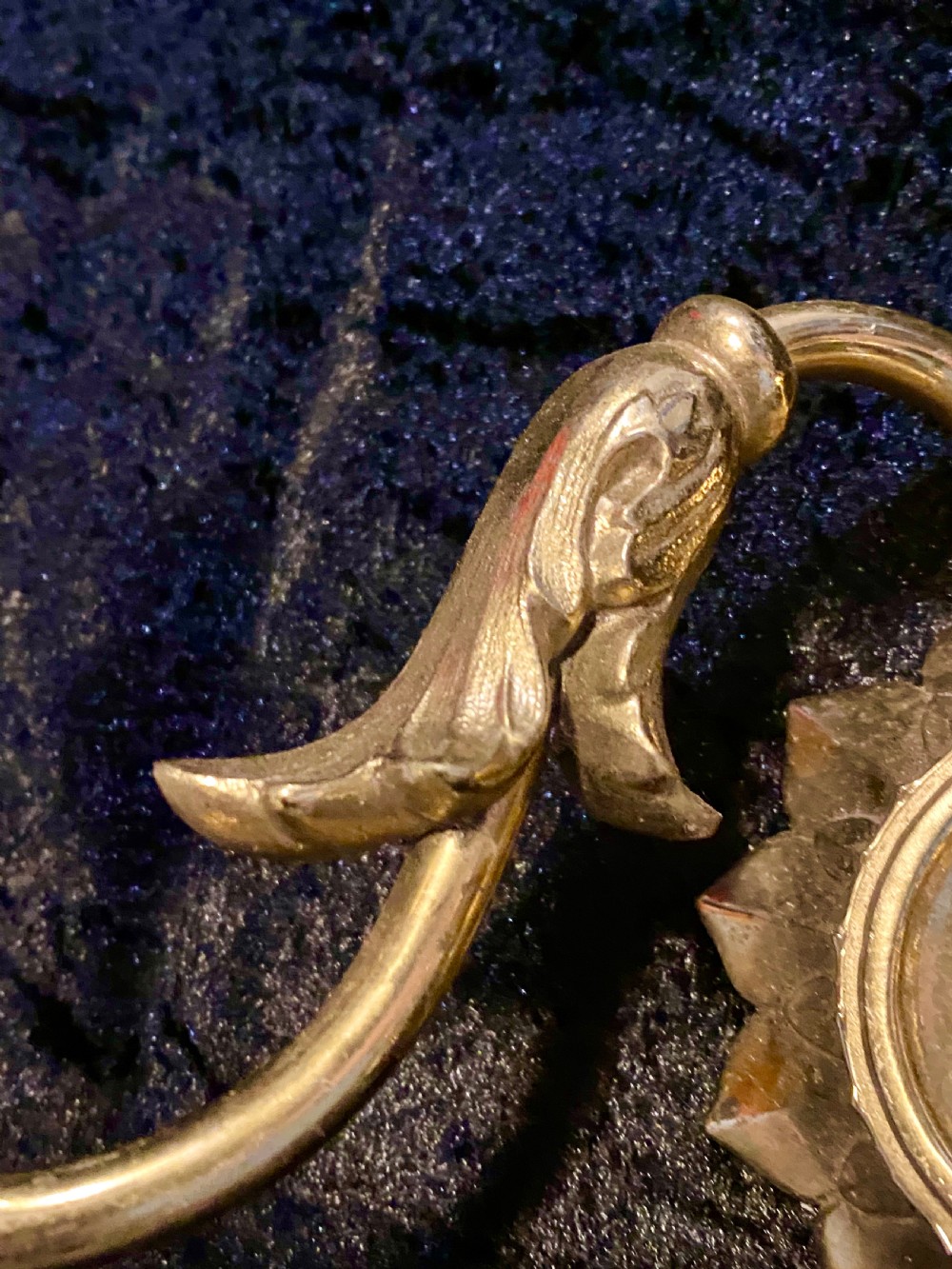 A pair of cast brass two-light wall sconces featuring sunburst backplates and curved acanthus leaf arms. View V