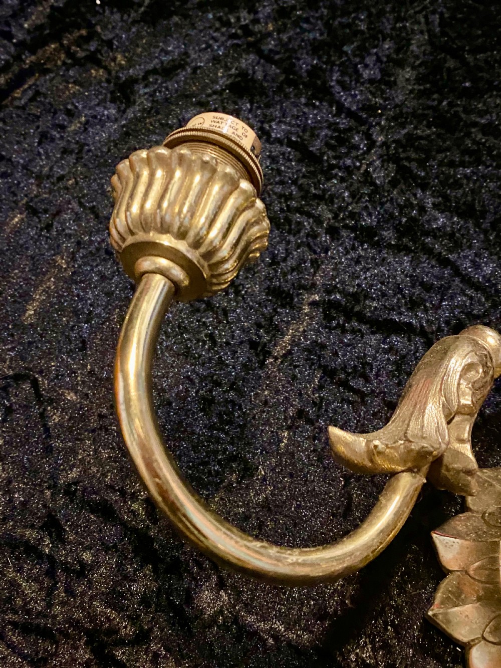 A pair of cast brass two-light wall sconces featuring sunburst backplates and curved acanthus leaf arms. View VI