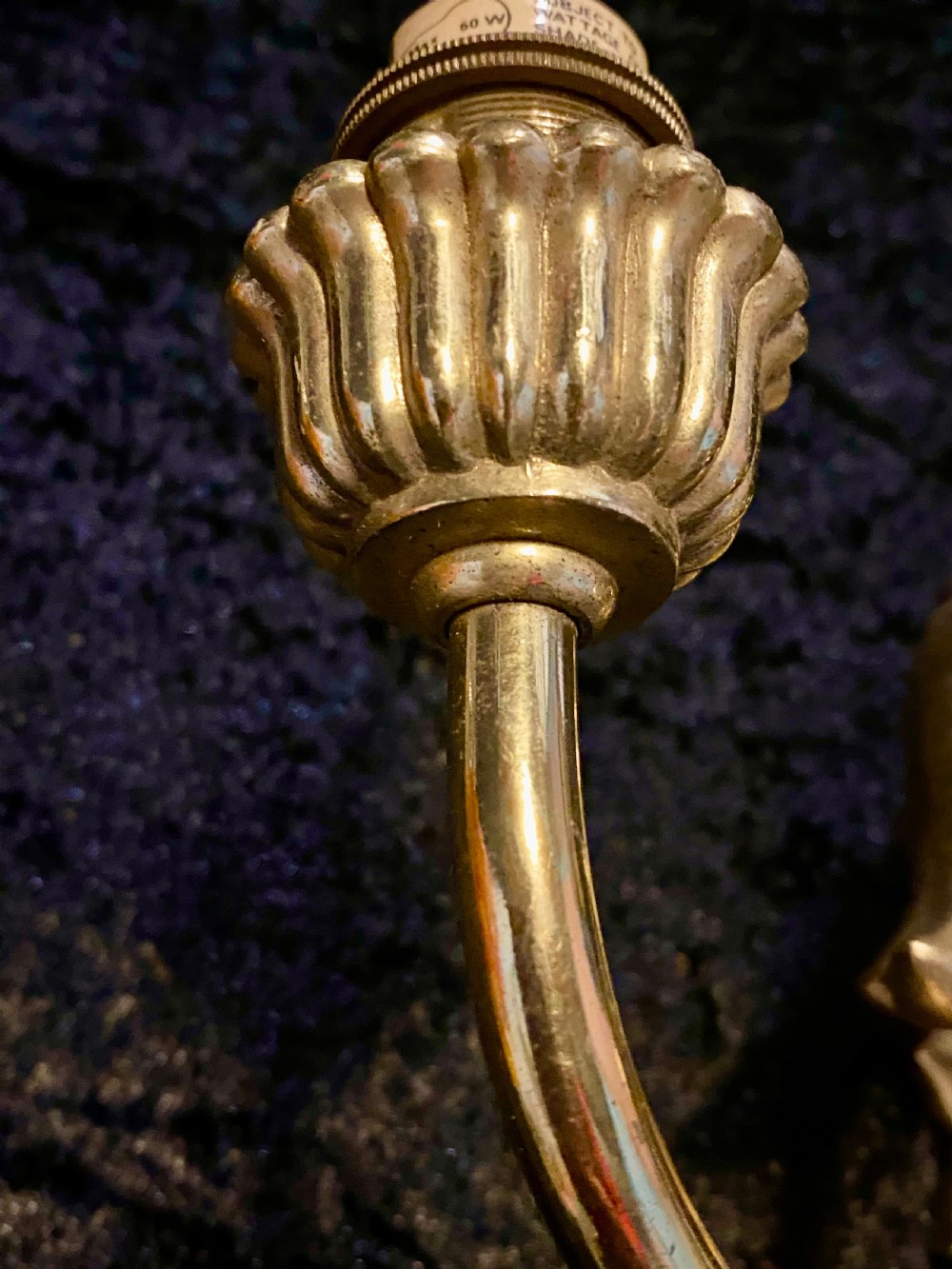 A pair of cast brass two-light wall sconces featuring sunburst backplates and curved acanthus leaf arms. View VII