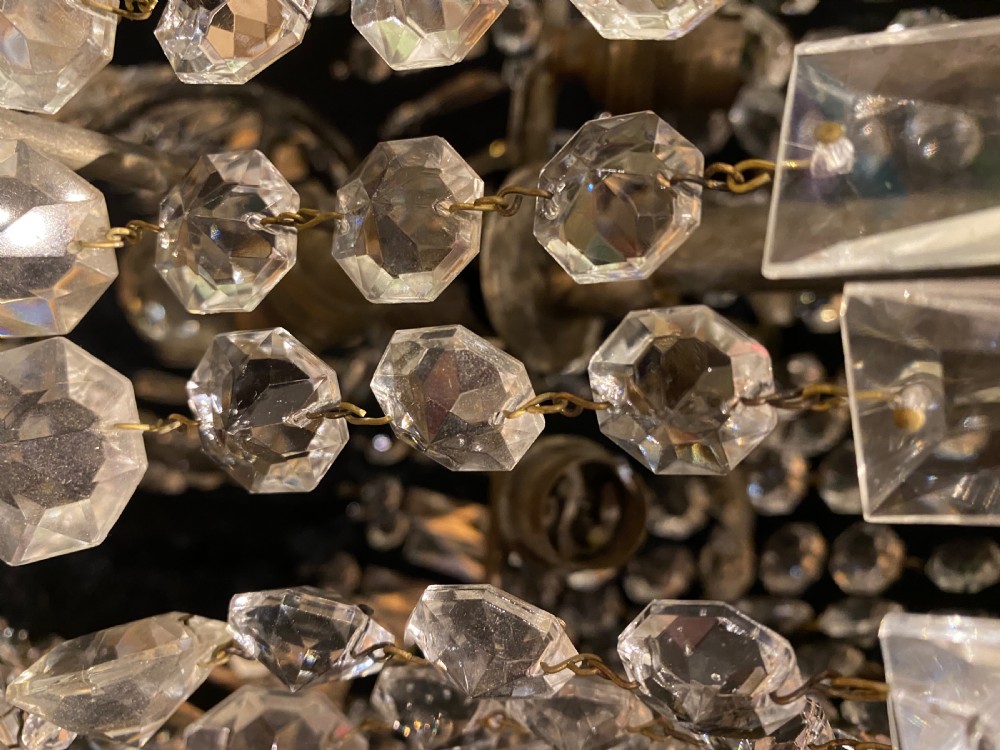 A pair of antique French tent and waterfall crystal chandeliers featuring concentric bands of cut glass prisms and octagonal beads suspended from metal hanging rings. View VI