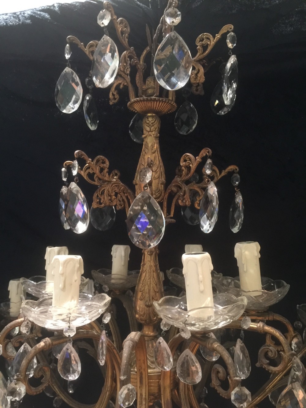 A two-tier Italian chandelier featuring a gilt metal frame adorned with crystal glass teardrop pendants and eighteen candle-style light sockets. View II
