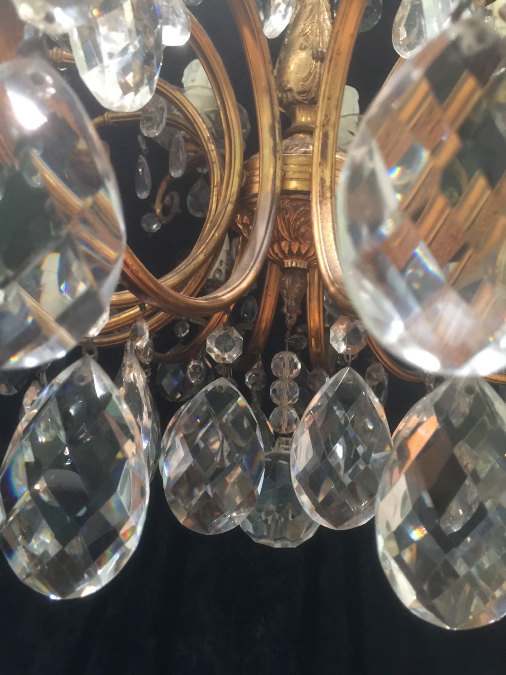 A two-tier Italian chandelier featuring a gilt metal frame adorned with crystal glass teardrop pendants and eighteen candle-style light sockets. View III