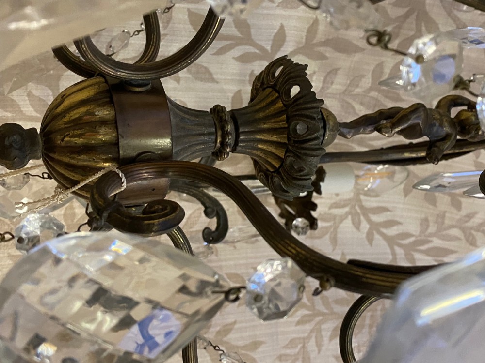 An Italian dark brass five-light chandelier adorned with crystal drops and a central metal cherub figurine. View XI
